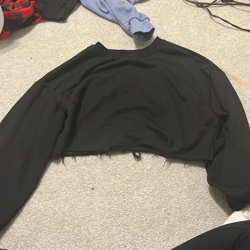 cropped black sweatshirt with pilling on the bottom
